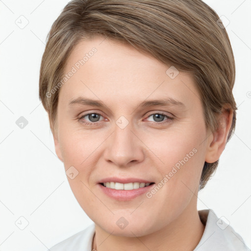 Joyful white young-adult female with short  brown hair and grey eyes