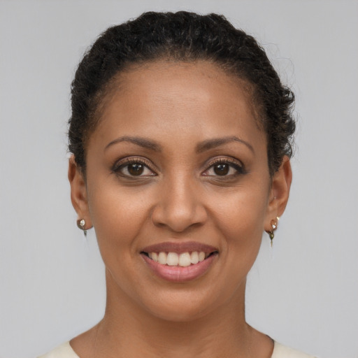 Joyful black young-adult female with short  brown hair and brown eyes
