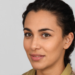 Joyful latino young-adult female with medium  brown hair and brown eyes