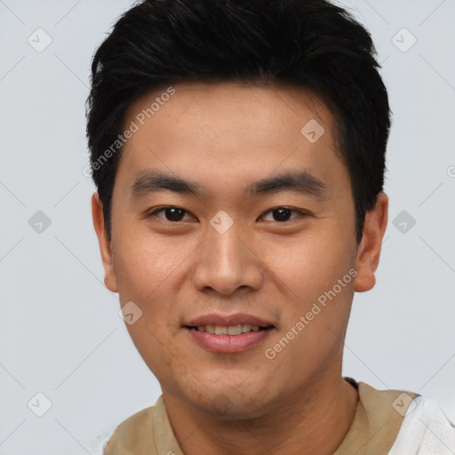 Joyful asian young-adult male with short  black hair and brown eyes