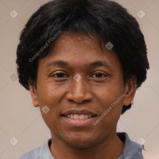 Joyful black adult male with short  black hair and brown eyes