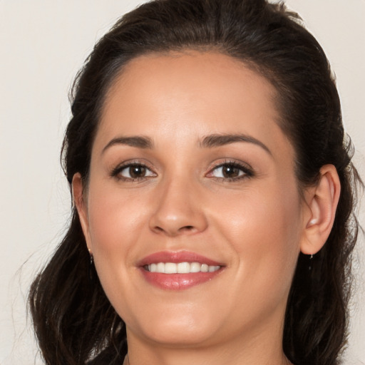 Joyful white young-adult female with long  brown hair and brown eyes