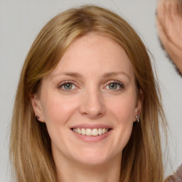 Joyful white adult female with long  brown hair and brown eyes