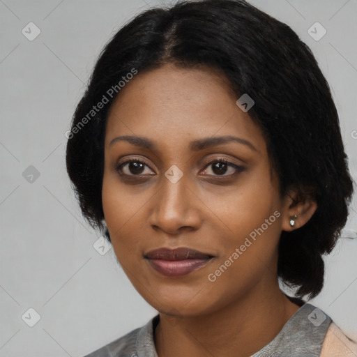 Joyful black young-adult female with medium  black hair and brown eyes