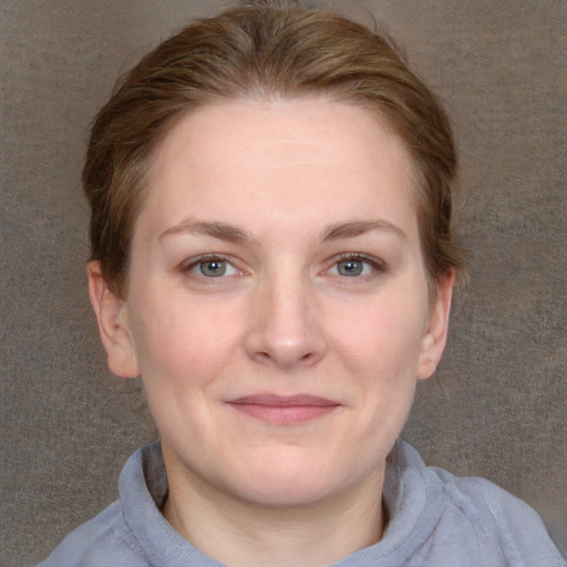 Joyful white young-adult female with long  brown hair and blue eyes