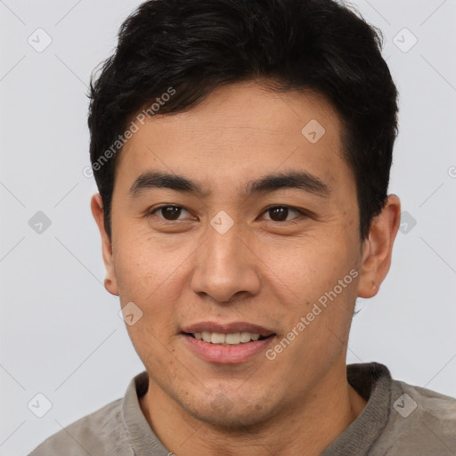 Joyful latino young-adult male with short  brown hair and brown eyes