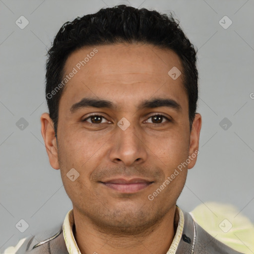 Joyful latino young-adult male with short  brown hair and brown eyes