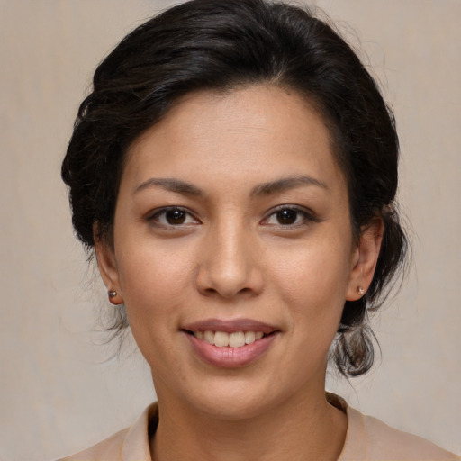 Joyful latino young-adult female with medium  brown hair and brown eyes