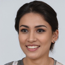 Joyful latino young-adult female with medium  brown hair and brown eyes