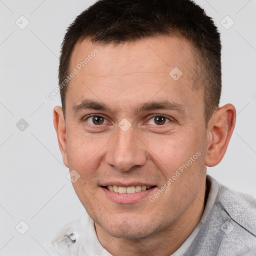 Joyful white adult male with short  brown hair and brown eyes