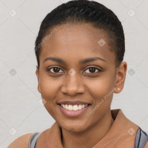 Joyful black young-adult female with short  black hair and brown eyes