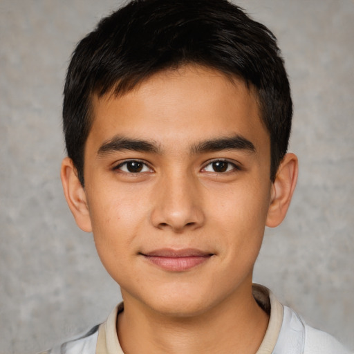 Joyful asian child male with short  brown hair and brown eyes