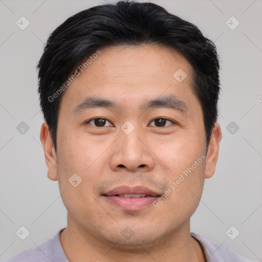 Joyful asian young-adult male with short  brown hair and brown eyes