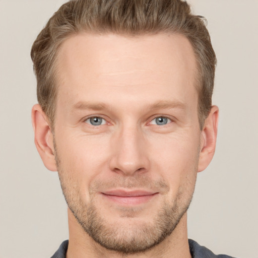 Joyful white adult male with short  brown hair and grey eyes