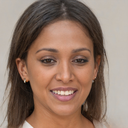 Joyful white young-adult female with long  brown hair and brown eyes