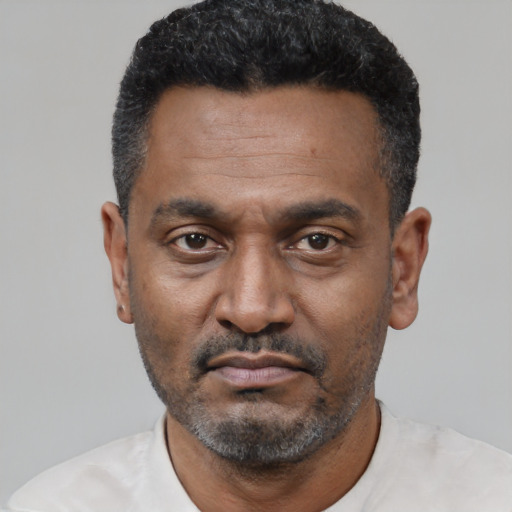 Neutral latino adult male with short  black hair and brown eyes