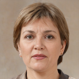 Joyful white adult female with medium  brown hair and grey eyes