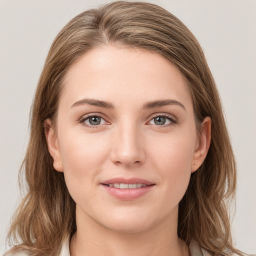 Joyful white young-adult female with long  brown hair and grey eyes