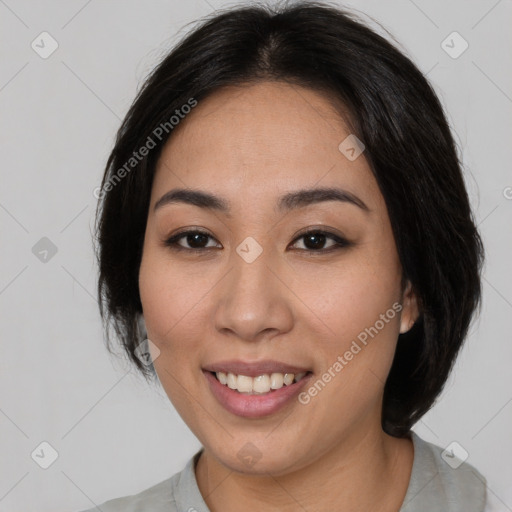 Joyful asian young-adult female with medium  black hair and brown eyes