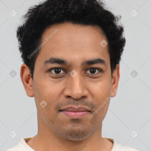 Joyful latino young-adult male with short  brown hair and brown eyes