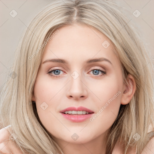 Joyful white young-adult female with long  brown hair and blue eyes