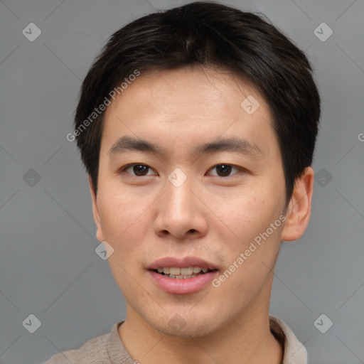 Joyful asian young-adult male with short  brown hair and brown eyes