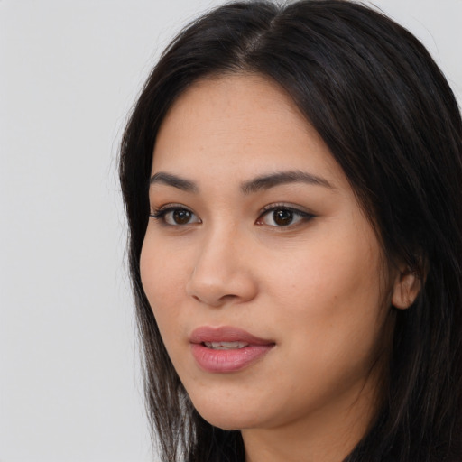 Joyful asian young-adult female with long  black hair and brown eyes