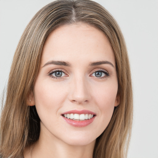 Joyful white young-adult female with long  brown hair and green eyes