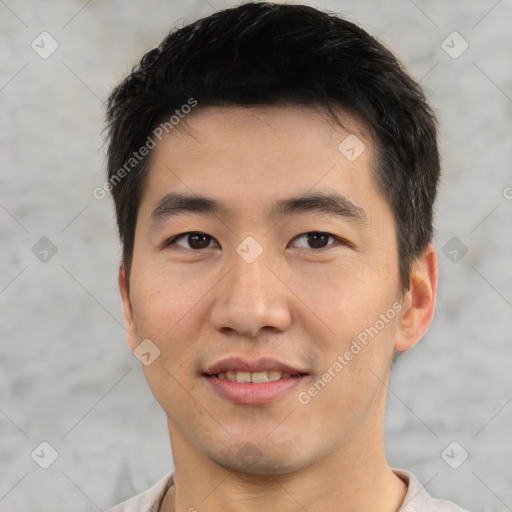 Joyful asian young-adult male with short  black hair and brown eyes