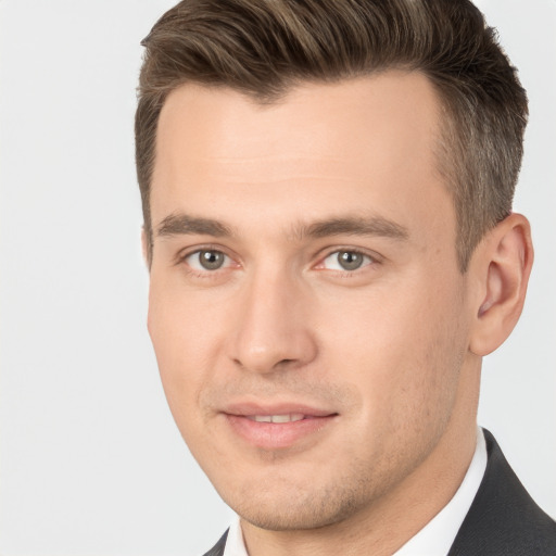 Joyful white young-adult male with short  brown hair and brown eyes