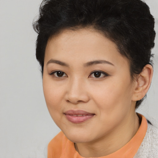 Joyful latino young-adult female with short  black hair and brown eyes