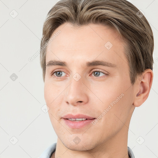 Joyful white young-adult male with short  brown hair and grey eyes