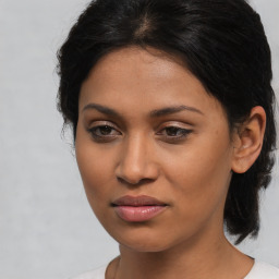 Joyful latino young-adult female with medium  brown hair and brown eyes