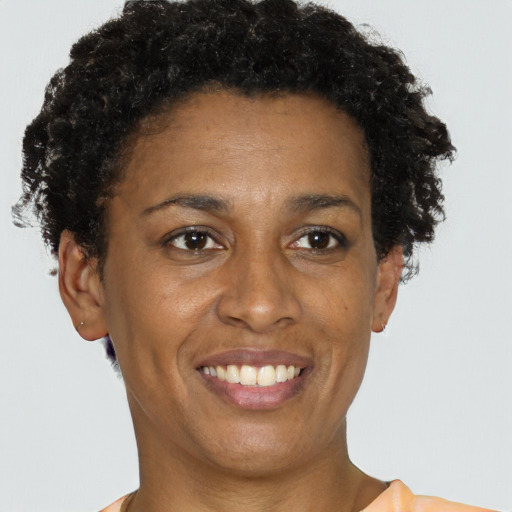 Joyful black young-adult female with short  brown hair and brown eyes