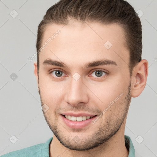 Joyful white young-adult male with short  brown hair and brown eyes