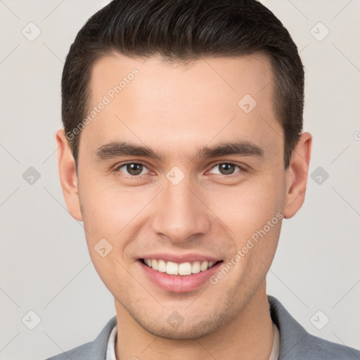 Joyful white young-adult male with short  brown hair and brown eyes