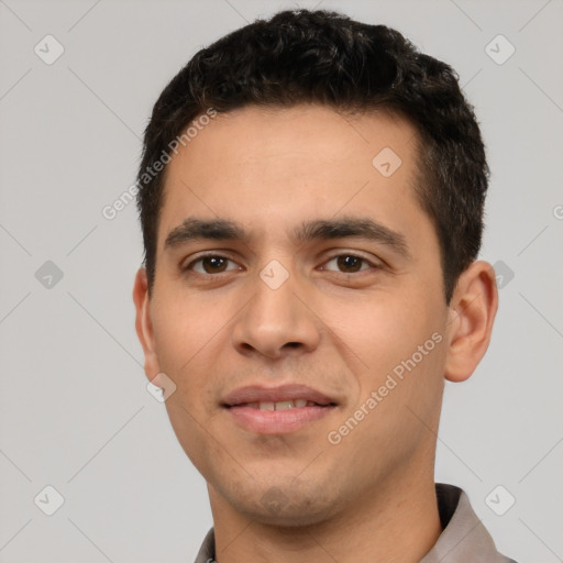 Joyful white young-adult male with short  black hair and brown eyes