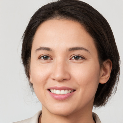 Joyful white young-adult female with medium  brown hair and brown eyes