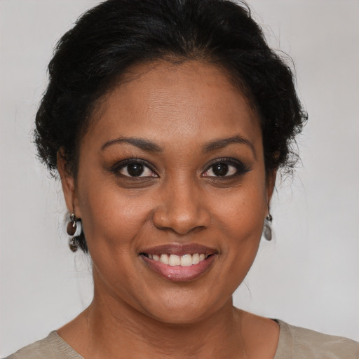 Joyful black adult female with short  brown hair and brown eyes