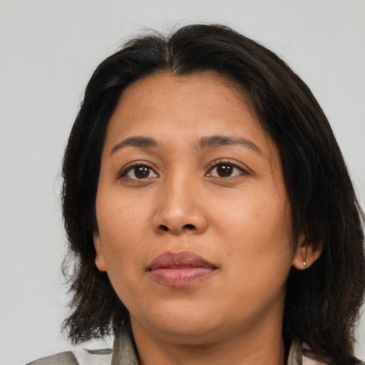 Neutral latino young-adult female with medium  brown hair and brown eyes