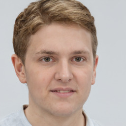 Joyful white adult male with short  brown hair and grey eyes