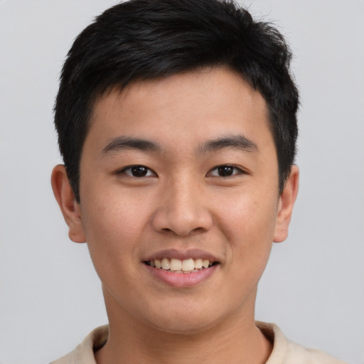 Joyful asian young-adult male with short  brown hair and brown eyes