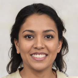 Joyful latino young-adult female with medium  brown hair and brown eyes