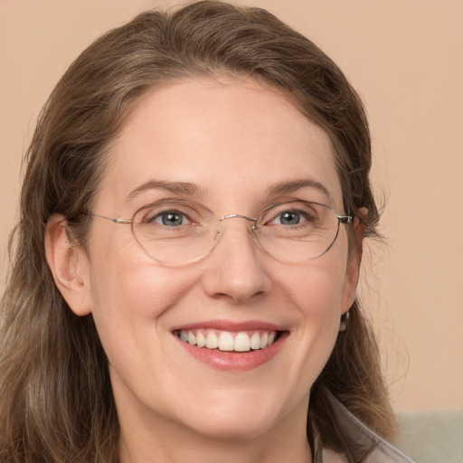 Joyful white adult female with medium  brown hair and grey eyes