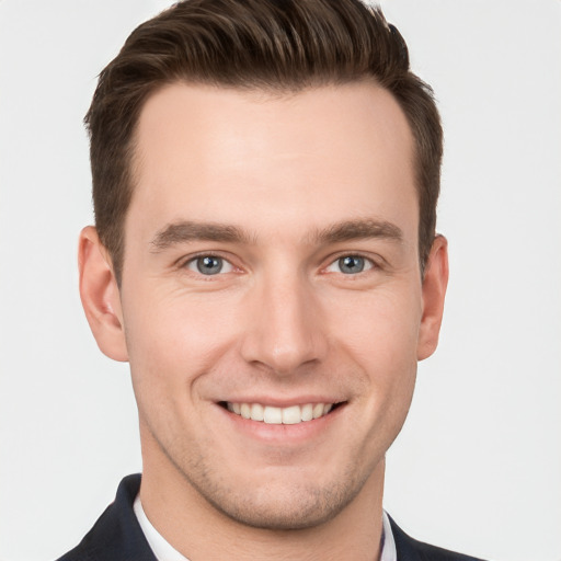 Joyful white young-adult male with short  brown hair and grey eyes