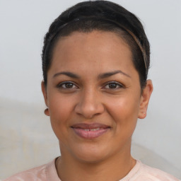 Joyful latino young-adult female with short  brown hair and brown eyes