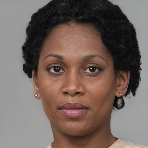 Joyful black adult female with short  black hair and brown eyes