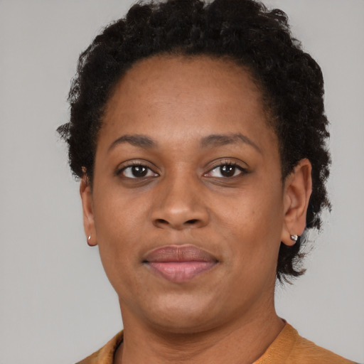Joyful black adult female with short  brown hair and brown eyes