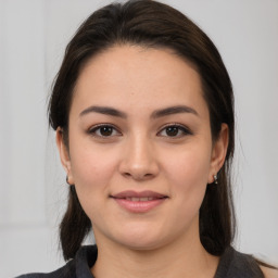 Joyful white young-adult female with medium  brown hair and brown eyes