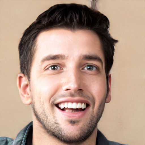 Joyful white young-adult male with short  black hair and brown eyes